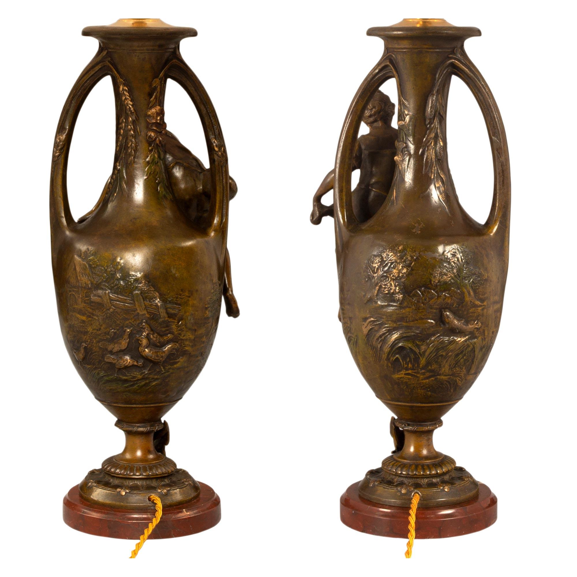 A true pair of French 19th century Louis XVI st. patinated bronze and Rouge Griotte lamps ...